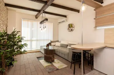 a living room with a couch and a table at The Balkan in Plovdiv