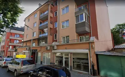 a large building with cars parked in front of it at The Balkan in Plovdiv