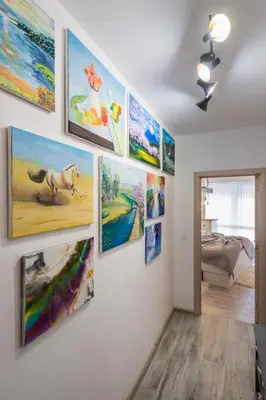 a wall full of paintings on a wall at The Balkan in Plovdiv