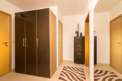 a bedroom with a large glass closet and a dresser at Nice and cozy flat in the center in Sofia