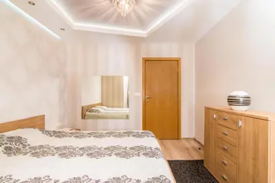 a bedroom with a bed and a dresser and a mirror at Nice and cozy flat in the center in Sofia