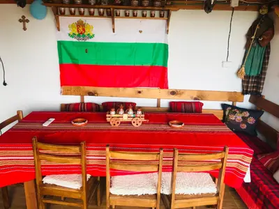 a table with a flag of nigeria on the wall at Guest house Grahlyov in Sapareva Banya