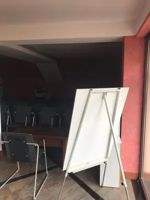 a white object sitting next to a red wall at Hotel Temenuga in Panichishte