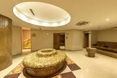a lobby with a large bowl in the middle of a room at Hotel Arena in Samokov