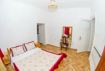 a bedroom with a bed and a chair in it at Central GuestHouse Five Corners in Sofia