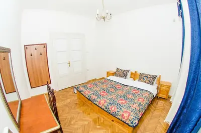 a bedroom with a bed in a room with a mirror at Central GuestHouse Five Corners in Sofia