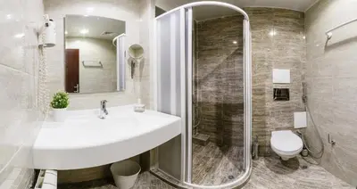 a bathroom with a sink and a shower and a toilet at Family Hotel Ring & Thermal in Kyustendil
