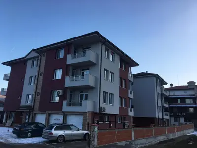 a building with two cars parked in front of it at ApartVel apartment 2 in Velingrad