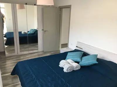 a bedroom with a blue bed with two towels at ApartVel apartment 3 in Velingrad