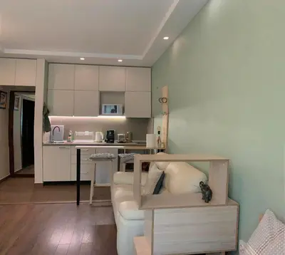 a living room with a couch and a kitchen at Exceptional Refurnished Studio TOP Location in Sofia
