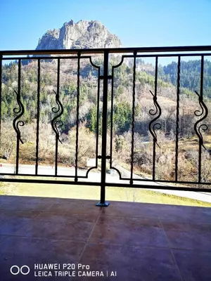a balcony with a view of a mountain at Ribkata Family Hotel in Smolyan