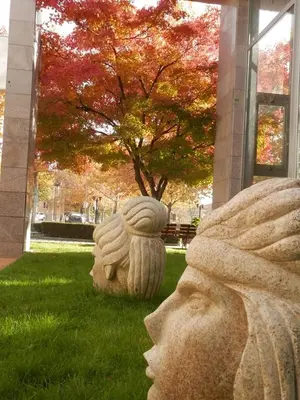 a statue of a head on the grass in front of a building at Апартамент 13 in Hisarya
