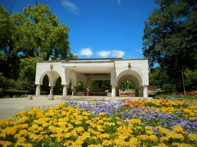 a white building with flowers in front of it at Апартамент 13 in Hisarya