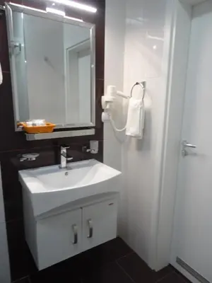 a bathroom with a white sink and a mirror at Апартамент 13 in Hisarya