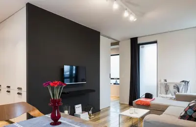 a living room with a couch and a tv on a wall at Set-up Design in Sofia