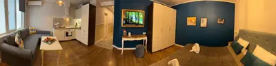 a living room with blue walls and a couch at Momenti & Colori Studios in Sofia