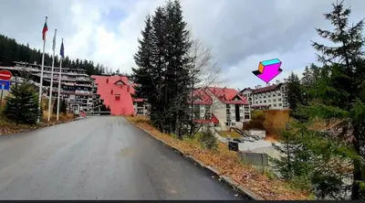 a kite flying in the air over a street at Apartment 9 in Pamporovo