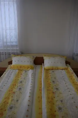 two beds sitting next to each other in a bedroom at Стаи за гости 