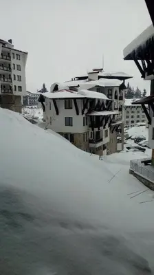 a pile of snow in front of some buildings at Apartment Аlex in Grand Monastery Pamporovo in Pamporovo
