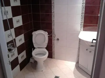 a bathroom with a toilet and a sink at Aleks Guest House in Samokov