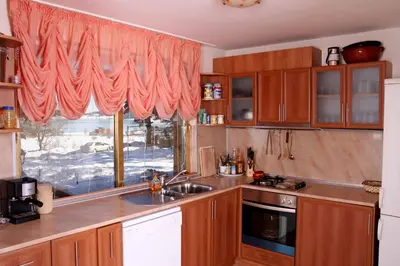a kitchen with a sink and a window at Guest house Lidia in Tsigov Chark