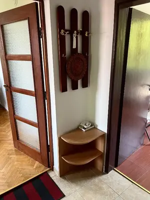 a room with a door and a shelf with a clock at Bankya Guest House - Sofia in Bankya