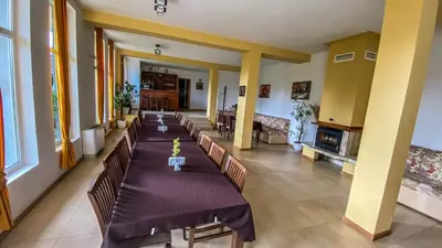 a large room with a long table and chairs at Guest House Au Nature in Golyama Zhelyazna