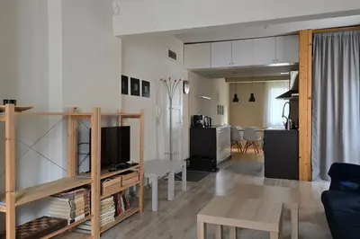 a living room and kitchen with a couch and a table at Red Door Apartment in Sofia