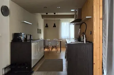 a kitchen with a counter and a dining room at Red Door Apartment in Sofia