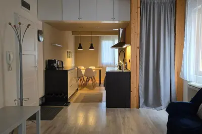 a living room with a kitchen and a dining room at Red Door Apartment in Sofia