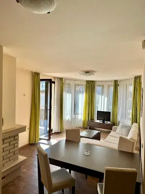 a living room with a couch and a table at House Laudis in Bansko