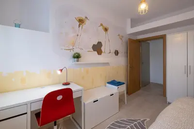 a room with a desk and a red chair at Two Bedroom Apartment Near to Doctors Garden in Sofia