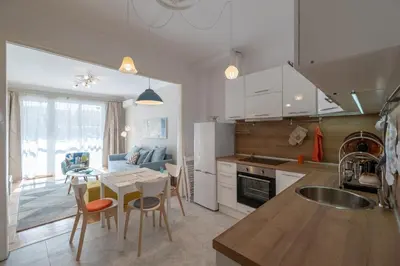 a kitchen and dining room with a table and chairs at Two Bedroom Apartment Near to Doctors Garden in Sofia