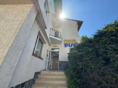 a building with a sign that reads server never slip at Семеен Хотел Вит in Teteven
