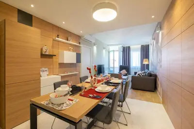 a kitchen and dining room with a table and chairs at Vitosha Blvd Luxury 2-Bedroom, 2-Bathroom with Balcony in Sofia