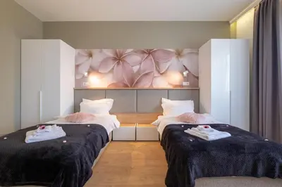 a hotel room with two beds with towels on them at Vitosha Blvd Luxury 2-Bedroom, 2-Bathroom with Balcony in Sofia