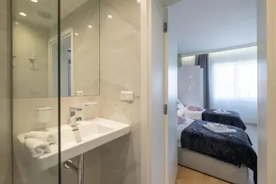 a bathroom with a sink and a bed at Vitosha Blvd Luxury 2-Bedroom, 2-Bathroom with Balcony in Sofia