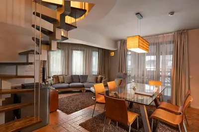 a living room with a table and a couch at Boutique Hotel Uniqato in Bansko