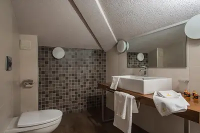 a bathroom with a sink and a toilet at Boutique Hotel Uniqato in Bansko