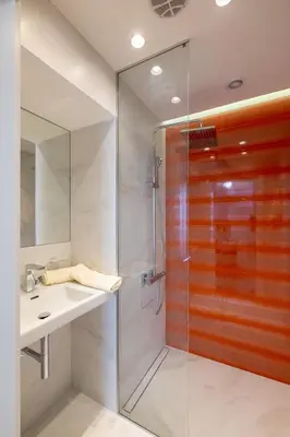 a bathroom with a glass shower and a sink at Vitosha Blvd 3-Bedroom, 2-Bathroom Lux Suite in Sofia