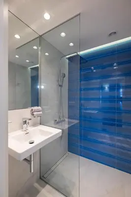 a bathroom with a sink and a glass shower at Vitosha Blvd 3-Bedroom, 2-Bathroom Lux Suite in Sofia