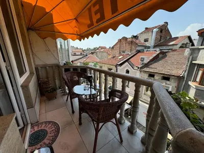 a balcony with a table and chairs on a balcony at Mini Hotel-Bohemi in Plovdiv