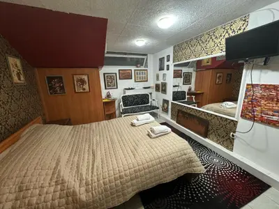 a bedroom with a bed and a mirror at Mini Hotel-Bohemi in Plovdiv