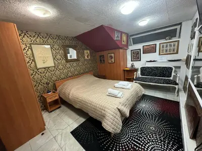 a small bedroom with a bed and a couch at Mini Hotel-Bohemi in Plovdiv