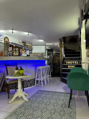 a bar with a table and chairs in a room at Mini Hotel-Bohemi in Plovdiv
