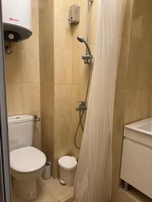a small bathroom with a toilet and a shower at Mini Hotel-Bohemi in Plovdiv