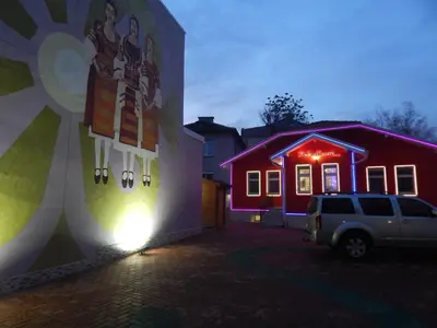 a car parked in front of a house with purple lights at Red House in Kyustendil