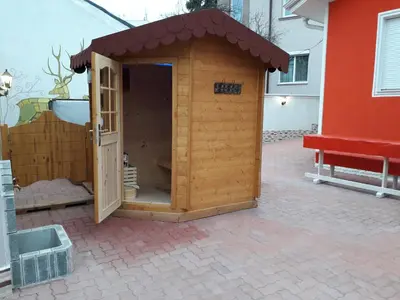 a small wooden dog house on a patio at Red House in Kyustendil