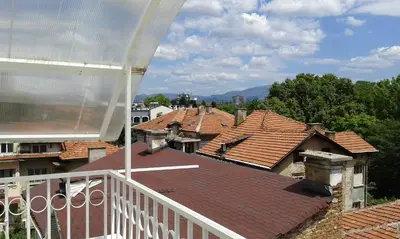 a view from a balcony of roofs of houses at Apartment Sagittarius in Kyustendil