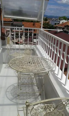a metal table and chairs on a balcony at Apartment Sagittarius in Kyustendil